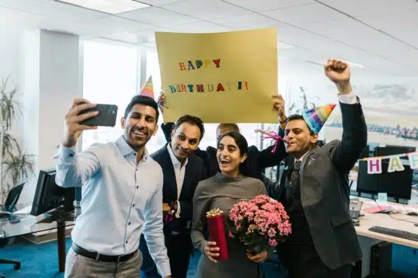 Group of employees taking a selfie for a birthday
