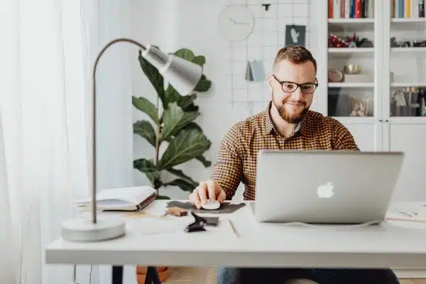 Man sitting at desk working on Macbook