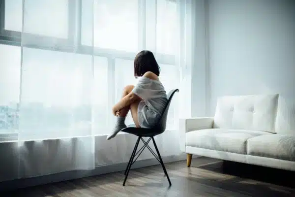 Career365.com.au_outplacement_woman alone in a room sitting on a chair